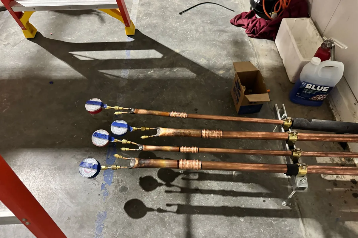 Brazing rig and gauges staged on the floor